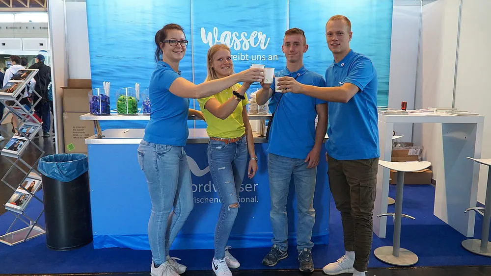 4 Personen stoßen mit Wasser an